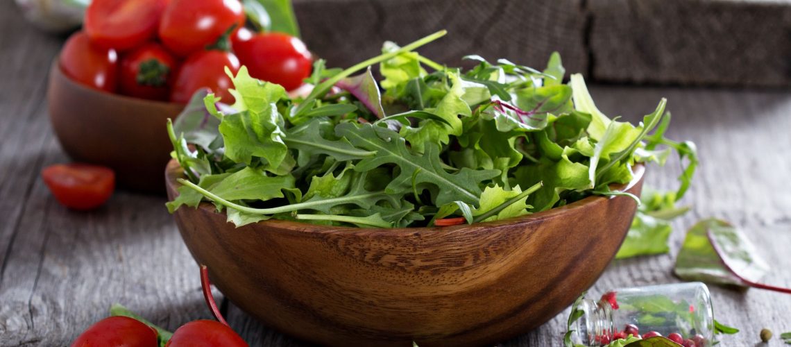 Mixed salad green leaves in a wooden bowl